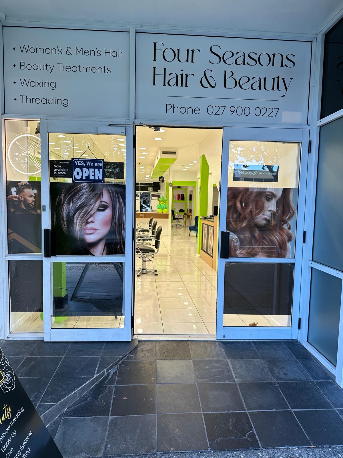 The entrance of Four Seasons Hair & Beauty with its services listed on the window
